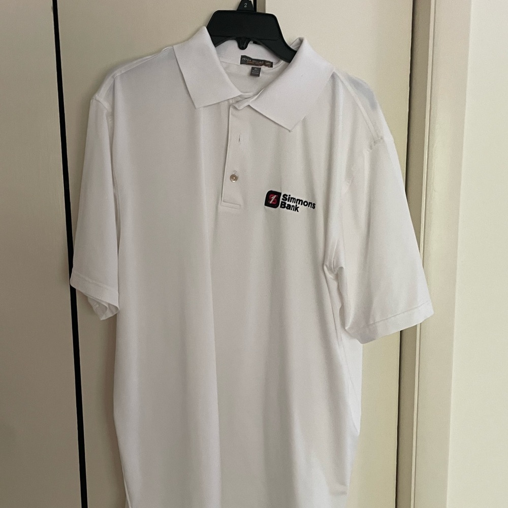 White Peter Millar polo with Simmons Bank logo. Will Zalatoris brand!